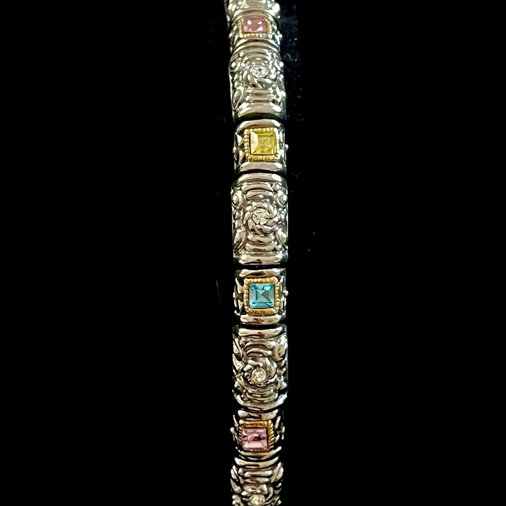 Multicolored crystals set in ornate silver link bracelet with magnetic clasp
